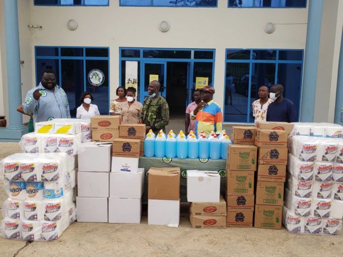 The General Manager, Akwasi Ossei Nkrumah (extreme) in pose with some of the representatives of beneficiary institutions and staff of the bank after the presentation